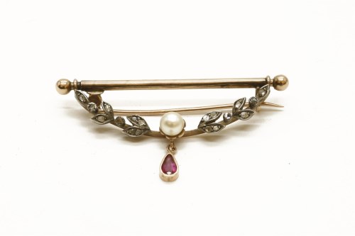 Lot 212 - A gold diamond and cultured pearl swag with a pear shaped ruby drop