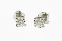 Lot 224 - A pair of white gold single stone illusion set diamond stud earrings