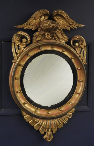 Lot 785 - A George III style convex mirror with eagle surmount