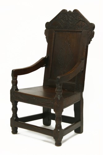 Lot 868 - A 17th century style oak panel back armchair