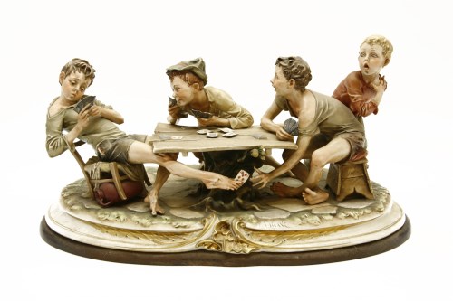 Lot 574 - Capodimonte 'The Gamblers' porcelain sculpture on a wooden base