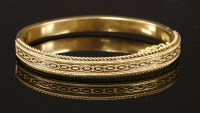 Lot 34 - A 15ct gold Victorian Etruscan-style hinged bangle