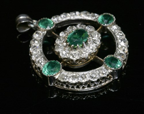Lot 79 - A late Victorian emerald and diamond circular target-style pendant