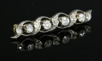 Lot 81 - A cased Victorian diamond set ribbon bar brooch