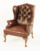 Lot 618 - A George III-style leather wingback armchair