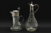 Lot 221 - A cut glass claret jug with silver plated mounts