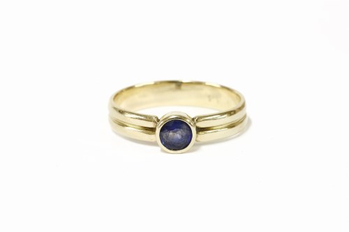Lot 55 - A gold single stone rub set sapphire ring