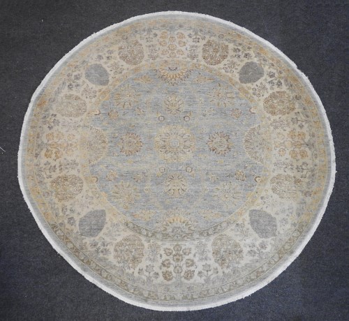 Lot 505 - A circular Persian rug