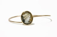Lot 7 - A gold carved hardstone cameo bangle