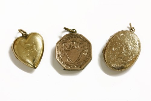 Lot 45 - A gold engraved oval locket with vacant cartouche