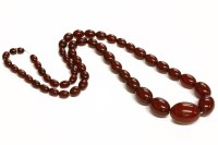 Lot 92 - A single row graduated cherry coloured olive shaped Bakelite beads