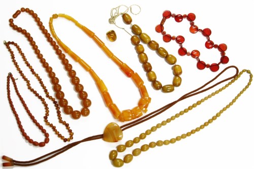 Lot 91 - A single row graduated taper barrel shaped amber early plastic bead necklace