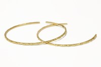 Lot 57 - Two high carat gold Indian bangles with engraved decoration