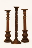 Lot 653 - A pair of carved mahogany bedpost jardiniere stands