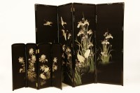 Lot 658 - A Japanese ebonised and embroidered four-leaf screen