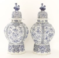 Lot 143 - A pair of Dutch delft octagonal baluster vases and covers