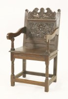 Lot 547 - An oak carved wainscot armchair