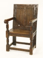 Lot 549 - An oak wainscot armchair