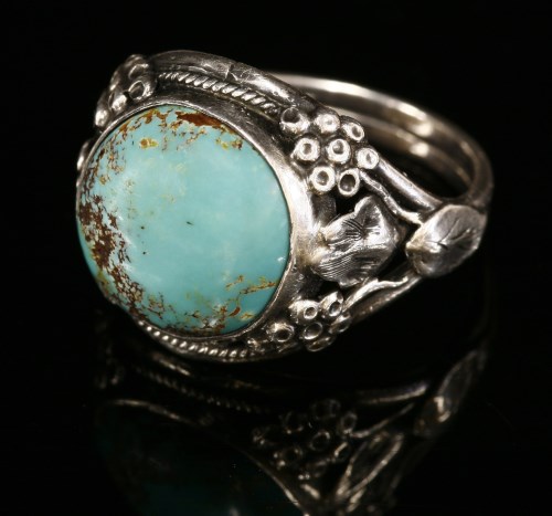 Lot 9 - An Arts and Crafts silver single stone turquoise cabochon ring