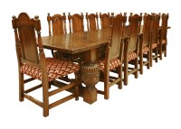 Lot 552 - An oak refectory table and twelve chairs