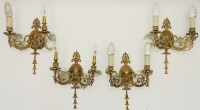 Lot 306 - A set of four neo-classical gilt metal two branch wall lights