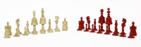 Lot 128 - A turned bone natural and red stained chess set