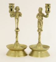 Lot 277 - A pair of continental figural brass candlesticks