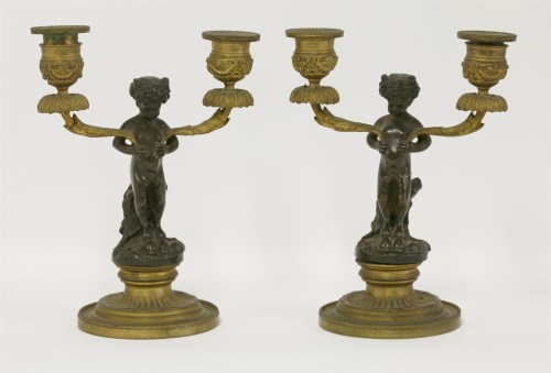 Lot 136 - A pair of 19th century of bronze and ormolu twin branch candelabra