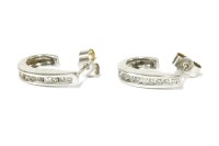 Lot 21 - A pair of 9ct white gold diamond set tapered hoop stud earrings