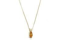 Lot 35 - A gold marquise cut orange sapphire pendant