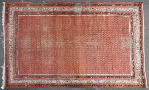 Lot 457 - A large red ground rug
