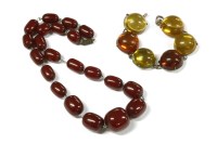 Lot 64 - A single row graduated barrel shape cherry coloured Bakelite bead necklace