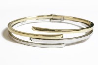 Lot 73 - A two colour 9ct gold crossover hinge bangle
11.98g