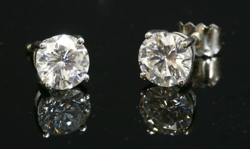 Lot 470 - A pair of 18ct white gold single stone diamond earrings