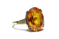 Lot 53 - A 9ct gold single stone oval mixed cut synthetic orange sapphire ring