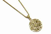 Lot 8 - A high carat gold open work floral circular pendant