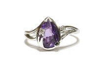 Lot 18 - A white gold pear shaped amethyst and diamond points ring