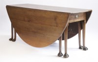 Lot 423 - A George II oak double drop-leaf table