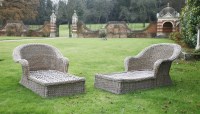 Lot 550 - A pair of wicker garden loungers with cushions