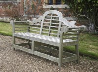 Lot 554 - A pair of teak garden seats in the manner of Edwin Lutyens