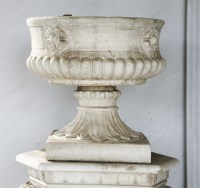 Lot 565 - A set of four reconstituted stone urns