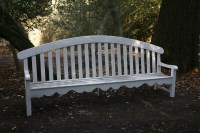 Lot 561 - A white painted wooden garden seat