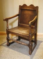 Lot 535 - An oak open arm wainscot chair