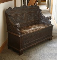 Lot 538 - A late Victorian stained oak box seat hall settle