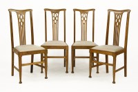 Lot 450 - A set of four Arts & Crafts oak high backed dining chairs