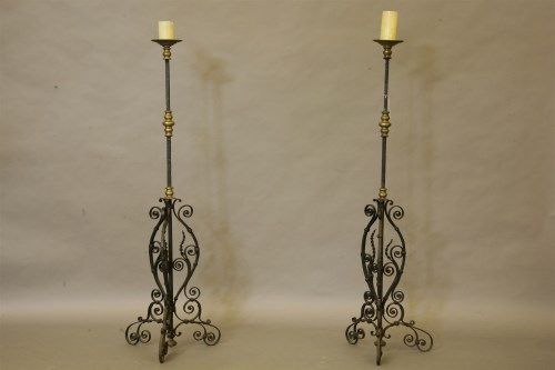 Lot 437 - A pair of 17th century style wrought iron and brass mounted large candle prickets