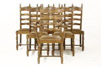 Lot 380 - A set of six oak ladder back dining chairs