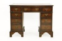Lot 366 - A George III style mahogany kneehole desk