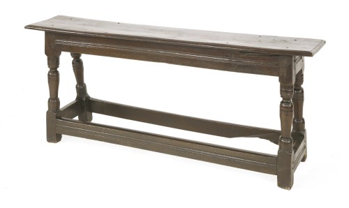 Lot 574 - An oak long stool