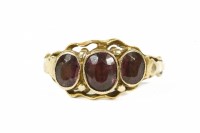 Lot 25 - A gold three stone garnet ring